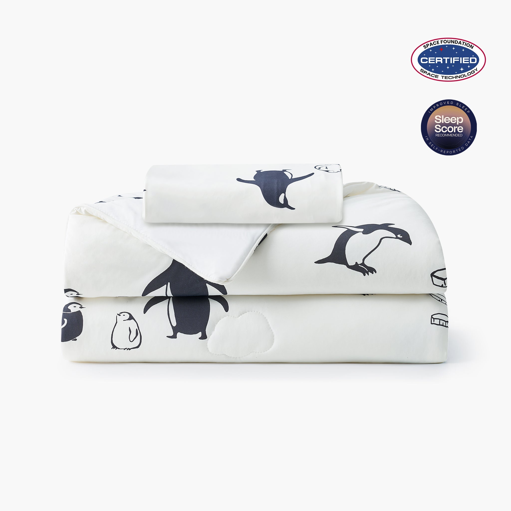 Folded White cooling comforter with penguin pattern on a white background, featuring Space Foundation and Sleep Score certification.#color_Antarctic Penguin